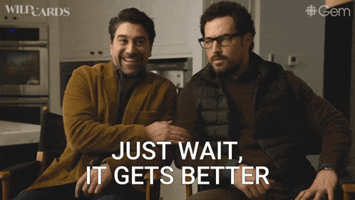 two men sitting next to each other with just wait it gets better written on the screen