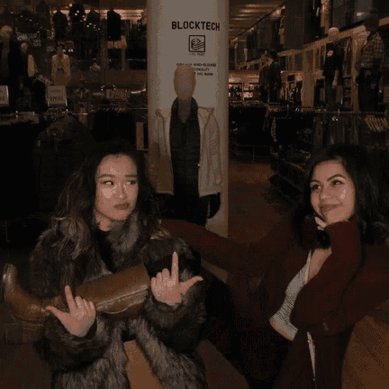 two women in front of a blocktech sign in a store