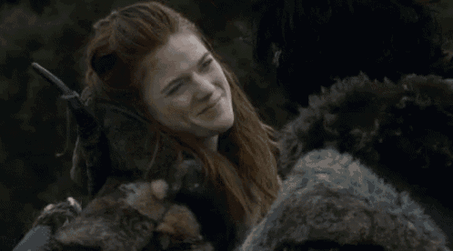 a woman with red hair says oh a spider while holding a sword