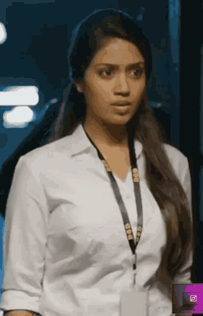 a woman in a white shirt has a lanyard around her neck that says ' cbn ' on it