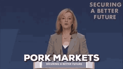 a woman stands at a podium with the words pork markets written on it