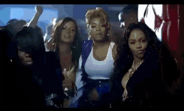a group of women are standing next to each other in a club .