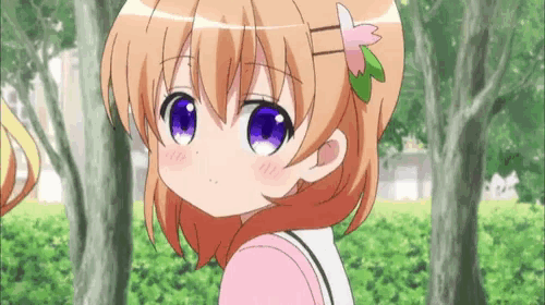 a little girl with a flower in her hair looks at the camera