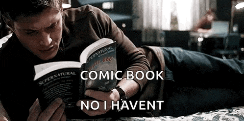 a man is laying on a bed reading a comic book and saying `` no i haven t '' .