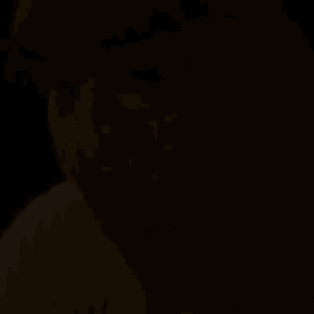 a close up of a man 's face with a tear coming out of his eye