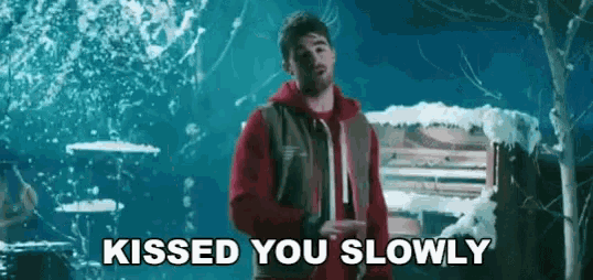a man in a red hoodie is standing in front of a piano in the snow and says kissed you slowly .