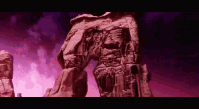 a statue of a man is standing in the middle of a desert .