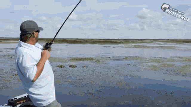 a man is fishing in a body of water with a sticker that says ' the fisherman ' on it