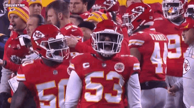 a football player with the number 53 on his jersey is surrounded by other players