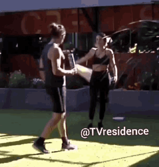 a man and a woman are standing next to each other on a grassy field with the words @tvresidence above them