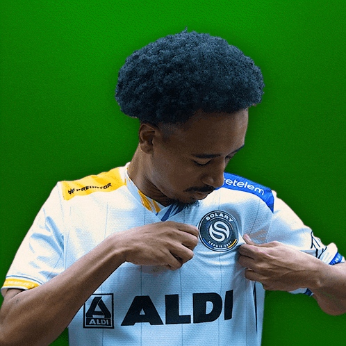 a man wearing a white shirt with the word aldi on the front