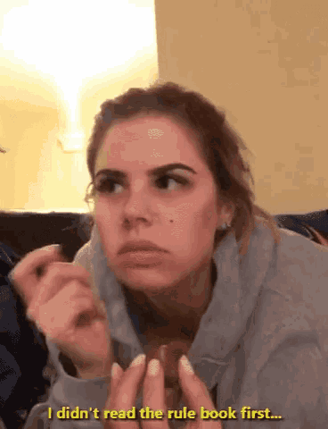 a woman sitting on a couch says i didn 't read the rule book first