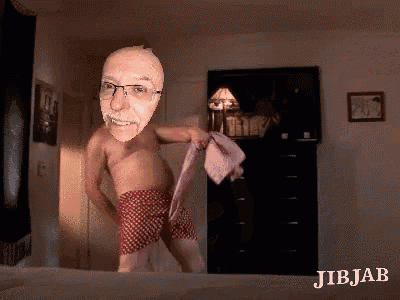 a man without a shirt is dancing on a bed with jibjab written on the bottom right