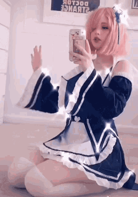a woman in a maid costume is taking a selfie with her phone .