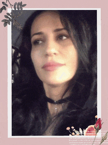 a woman 's face is framed by flowers and leaves on a pink background