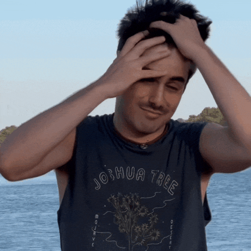 a man wearing a black shirt that says joshua tree