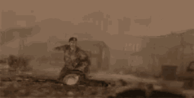 a man in a military uniform is kneeling on the ground