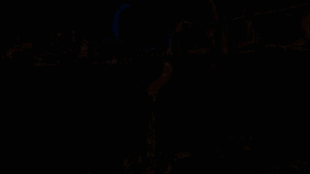 a man in a red shirt is walking down a street at night with a large billboard behind him