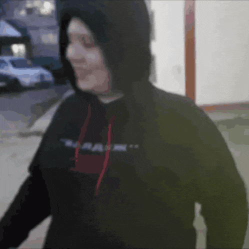 a person wearing a hoodie and a sweatshirt with the word ram on it .