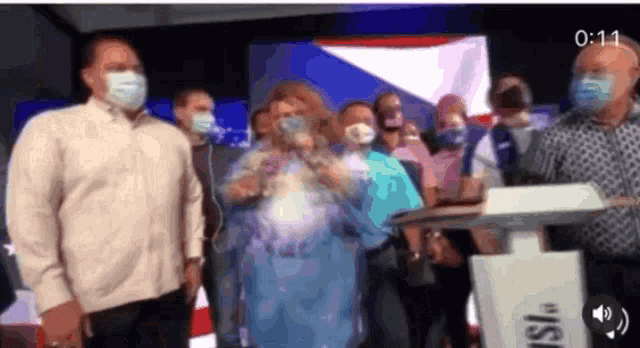 a group of people wearing face masks are standing around a podium that says ' iis ' on it