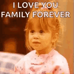 a little girl is saying `` i love you family forever '' while sitting on a bed .