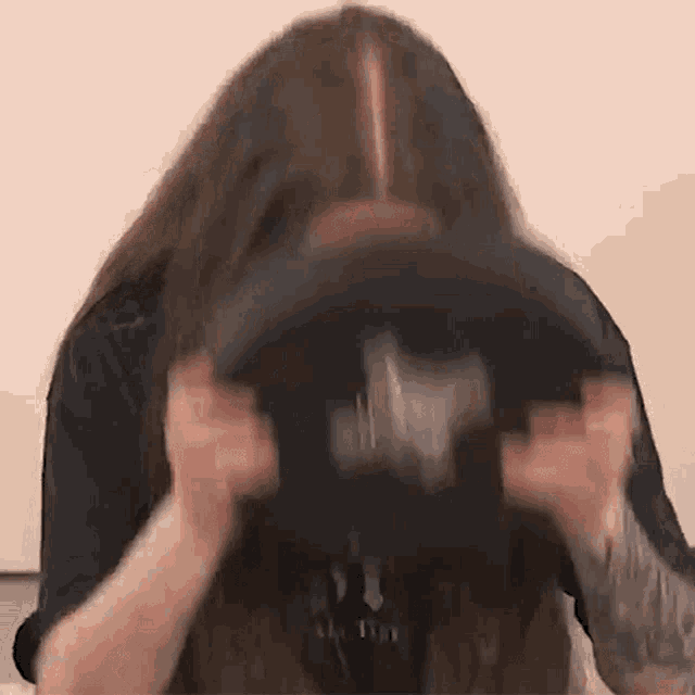 a woman with long hair is playing a video game with a controller .