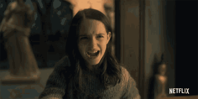 a girl is smiling in front of a netflix advertisement