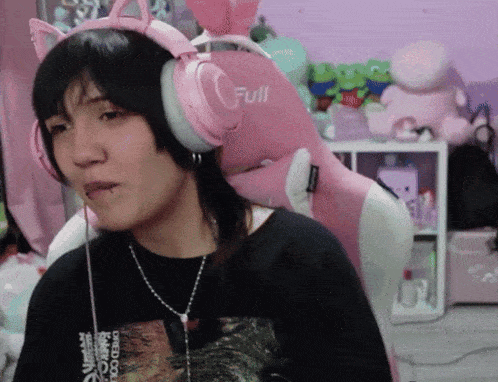 a woman wearing pink headphones that say full