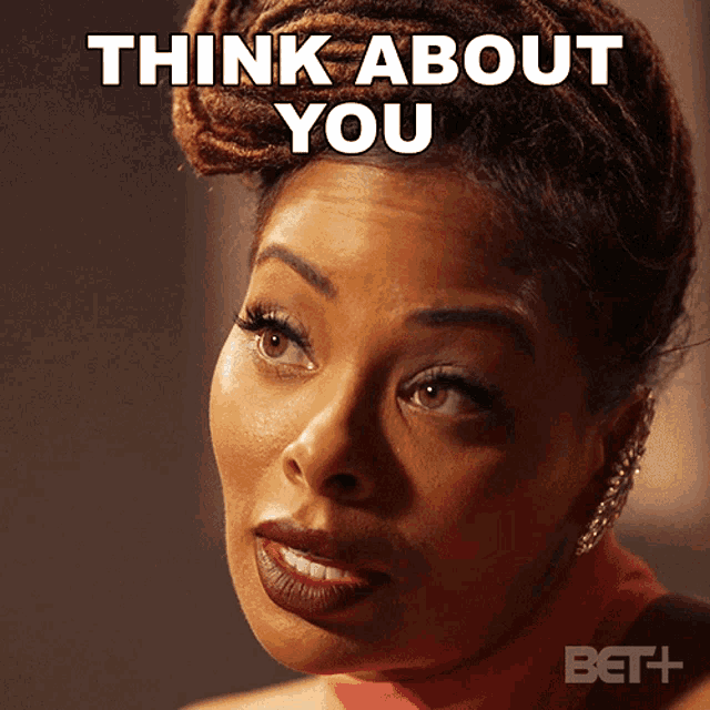 a woman with dreadlocks says think about you on her face