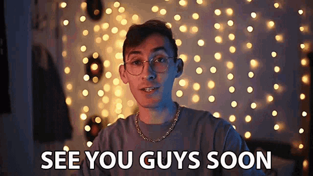a man wearing glasses and a gold chain says see you guys soon