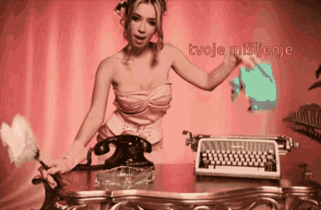 a woman in a pink dress is standing next to a typewriter and a feather duster