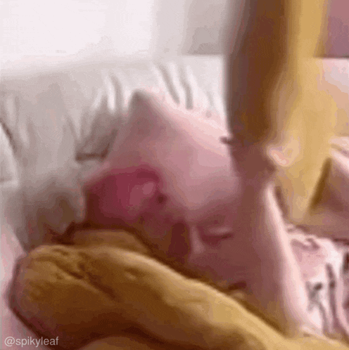 a close up of a person laying on a couch with a yellow blanket .