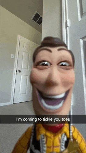 a woody doll is making a funny face and says i 'm coming to tickle you toes