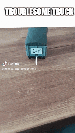 a toy truck with a face on it is on a wooden table and says troublesome truck