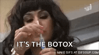 a woman is holding a syringe in her hand and saying it 's the botox .