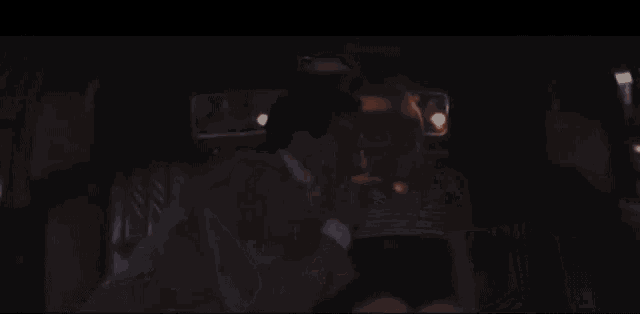 a man and woman are kissing in a car .