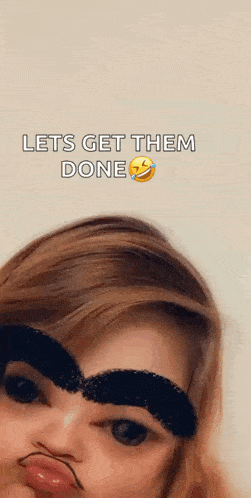 a woman with a fake mustache and eyebrows is making a funny face .