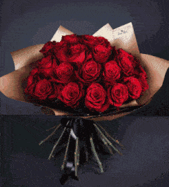 a bouquet of red roses with the name queen beyaz written on the bottom