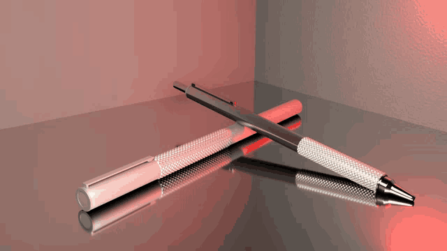 two pens are laying on a table with a red light behind them