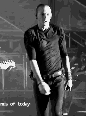 a man in a black shirt is standing on a stage in front of a sign that says " hands of today "