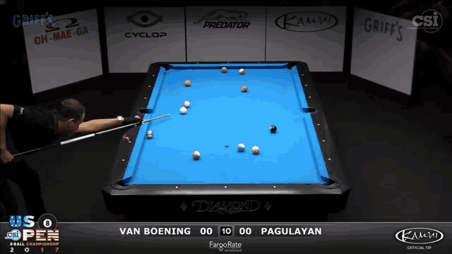 a pool table with a blue cloth and a man holding a cue