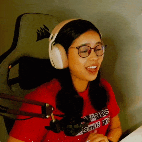 a woman wearing headphones and a shirt that says " arias "