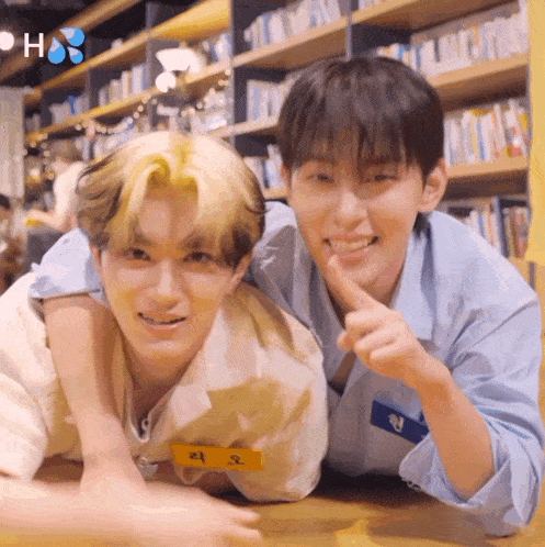 two young men are laying on the floor and one of them has a name tag that says ' ao ' on it