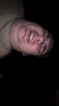 a blurry picture of a man making a funny face with his eyes closed