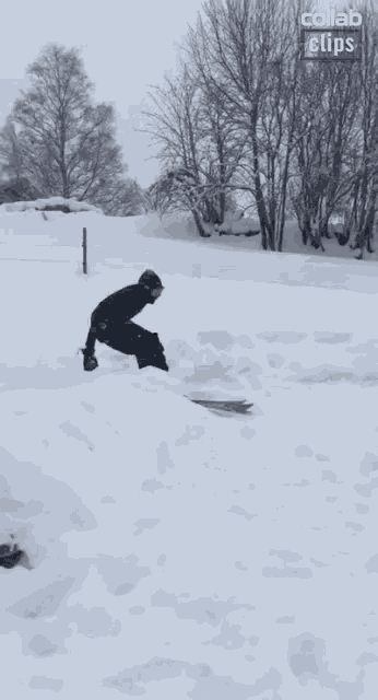 a snowboarder is doing a trick in the snow with a collab clips logo in the corner