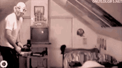 a man in a clown mask is standing in front of a bed in a room with the website onlylolgifs.net visible
