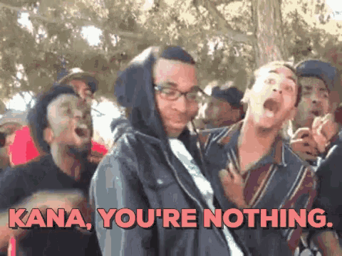 a man in a hooded jacket says kana you 're nothing in front of a crowd of people