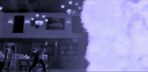 a blurry picture of a room with a purple smoke coming out of the corner