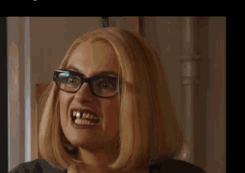 a close up of a woman wearing glasses and a wig