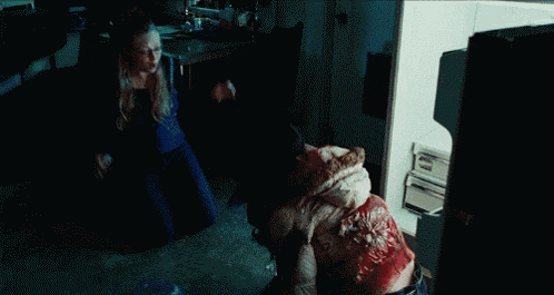 a woman with blood coming out of her mouth is eating something